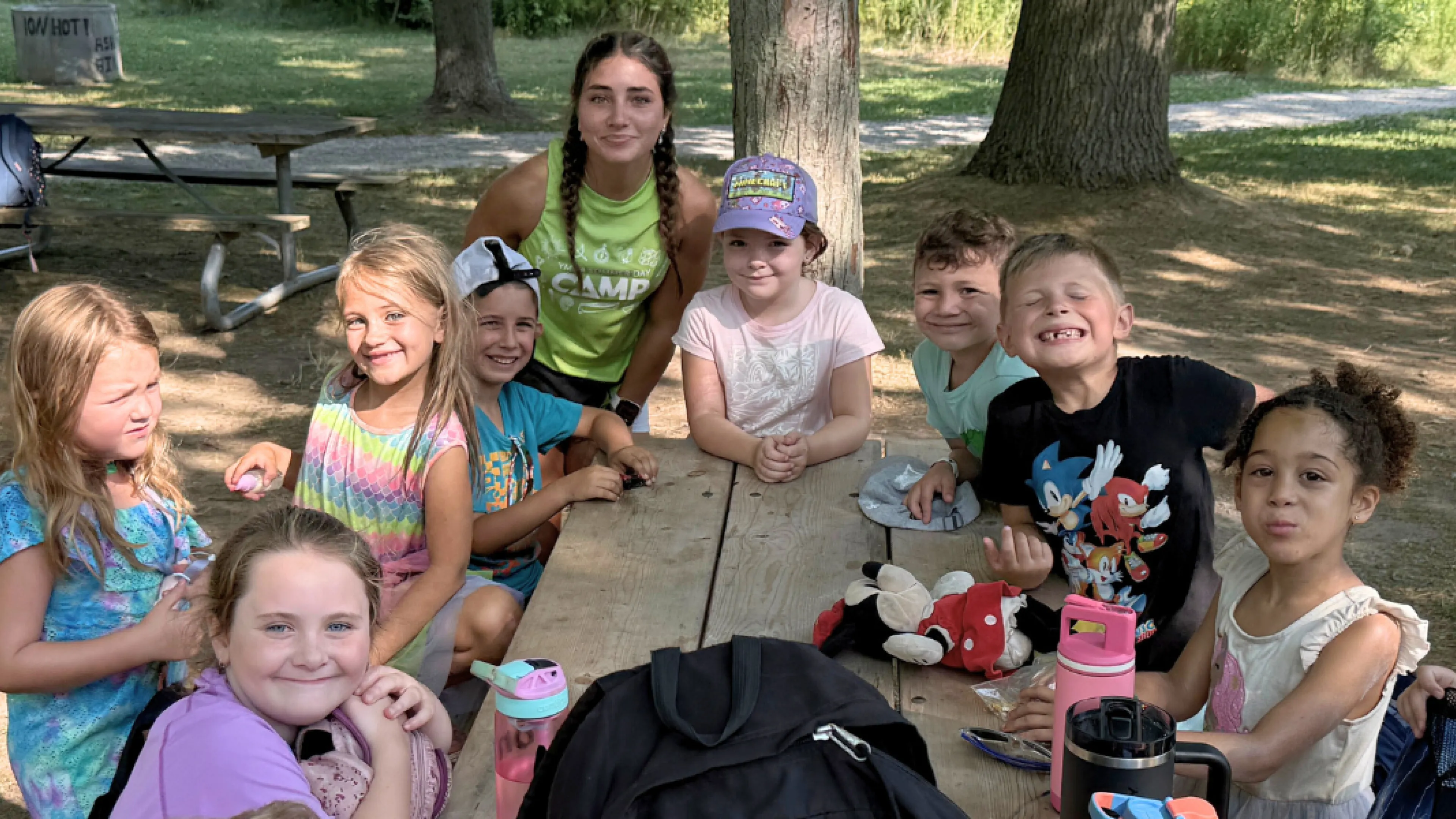 Group of kids at a bench smiling