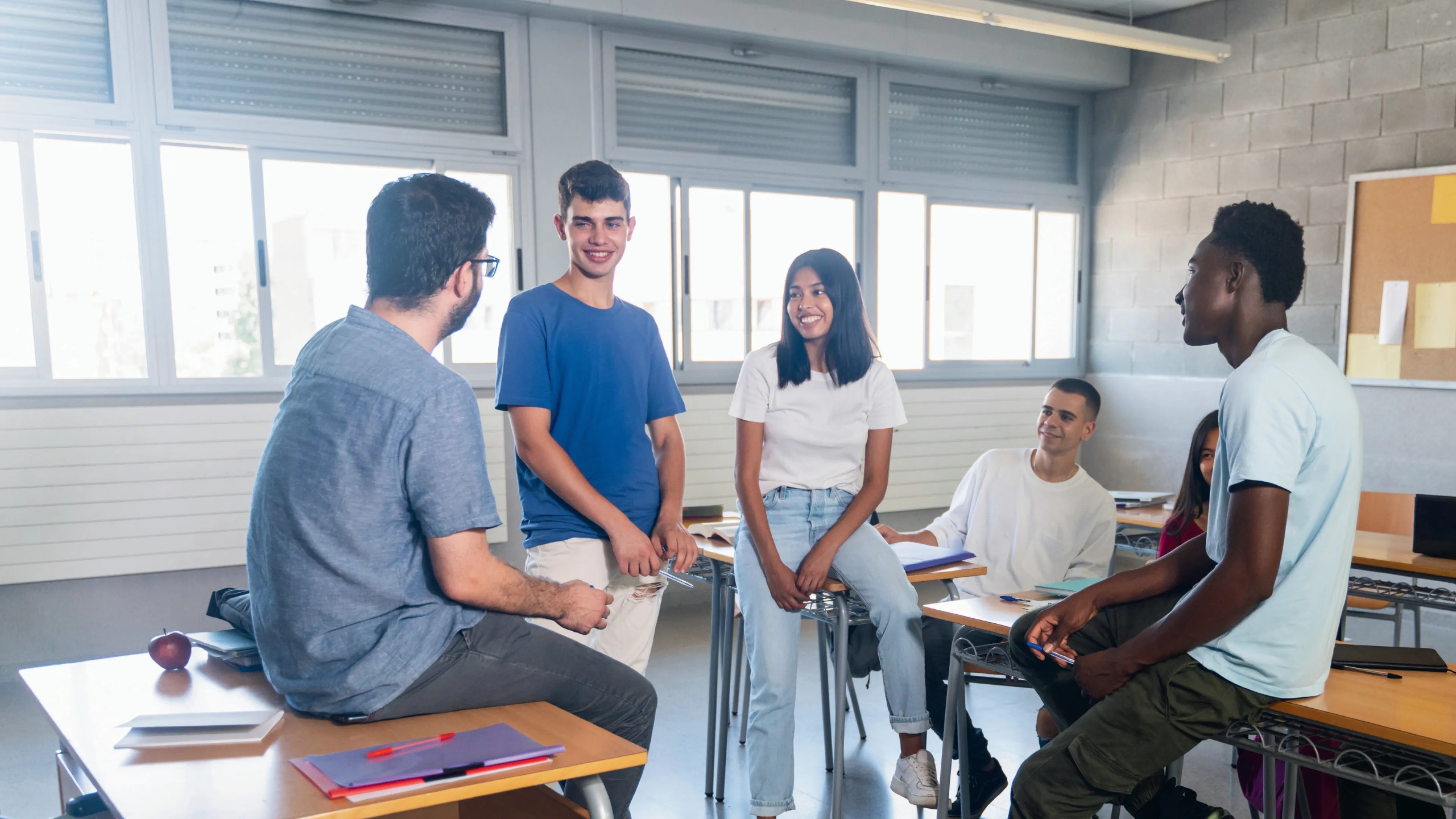 Groups of teens sitting in a classroom