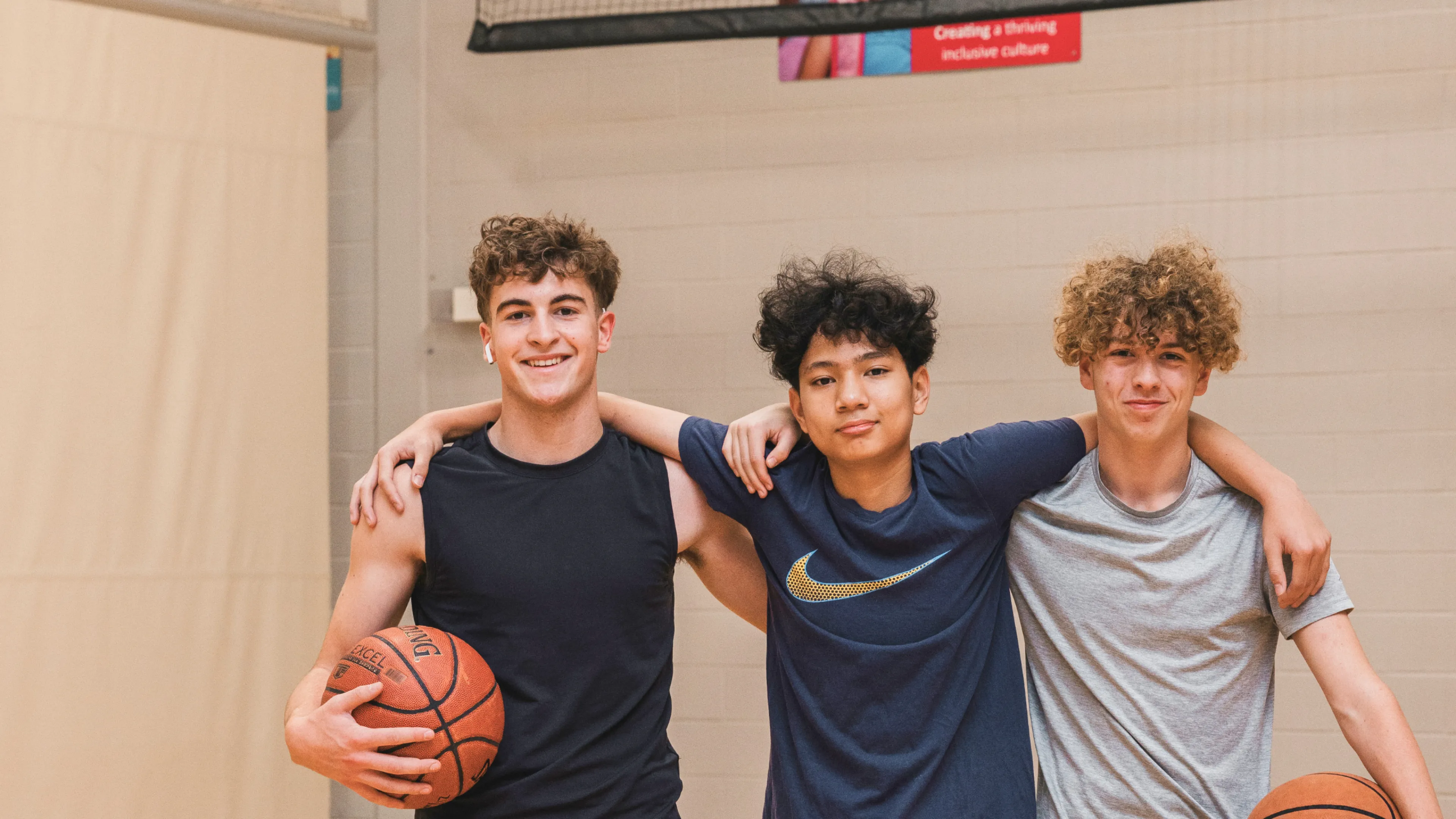 Three boys on basketball court