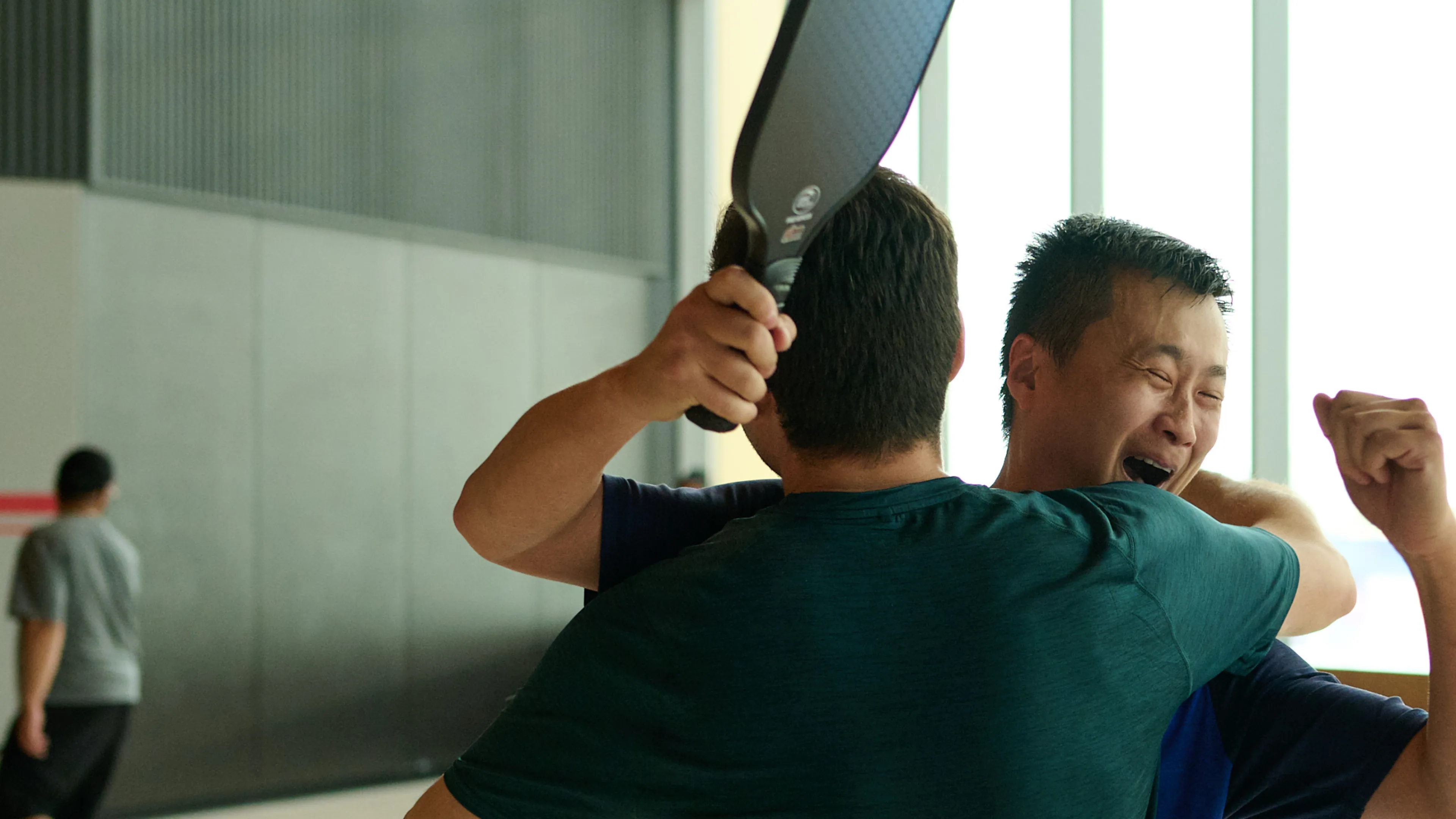 Two men celebrating playing pickleball