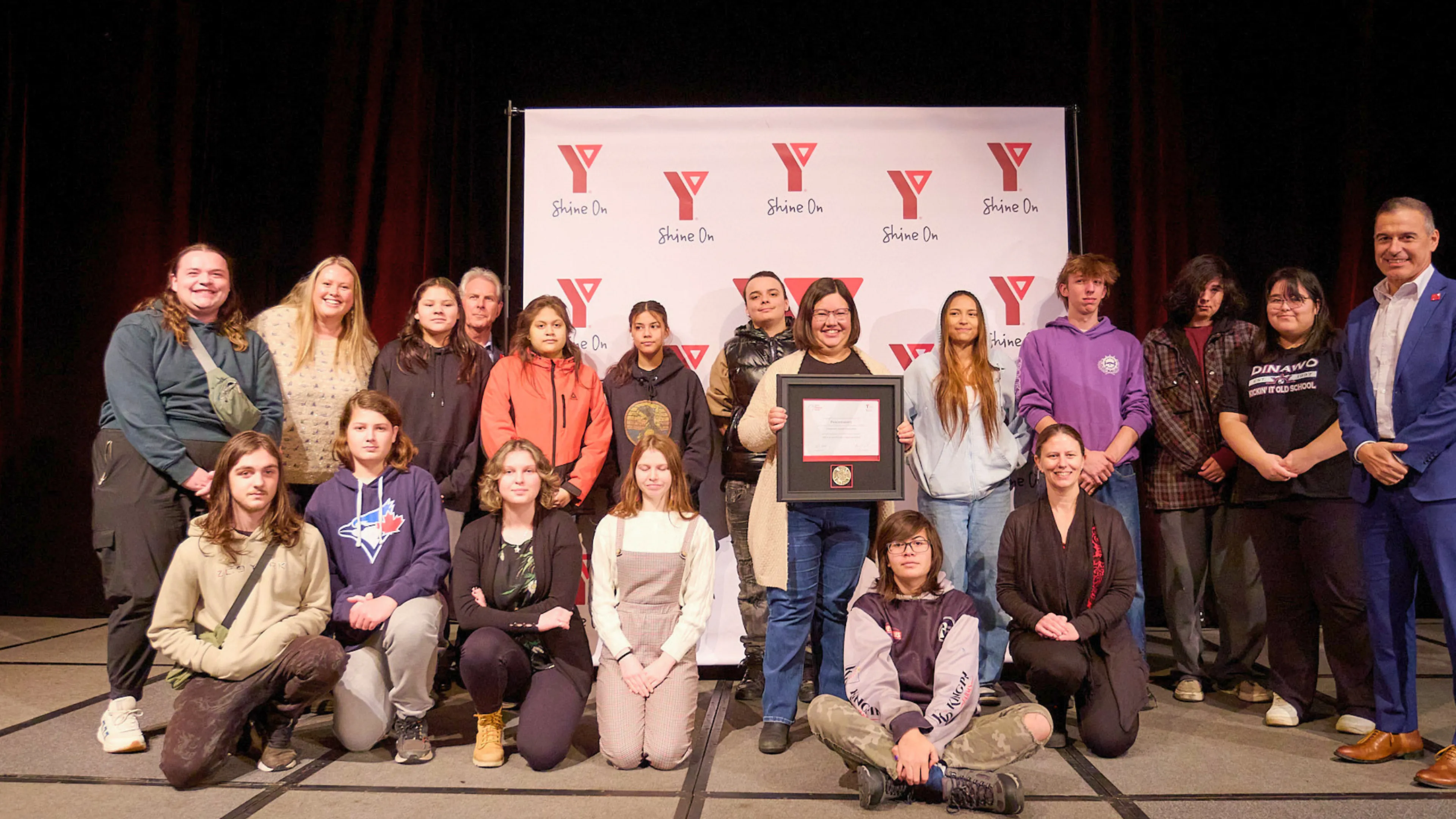 Group of people getting an award on stage