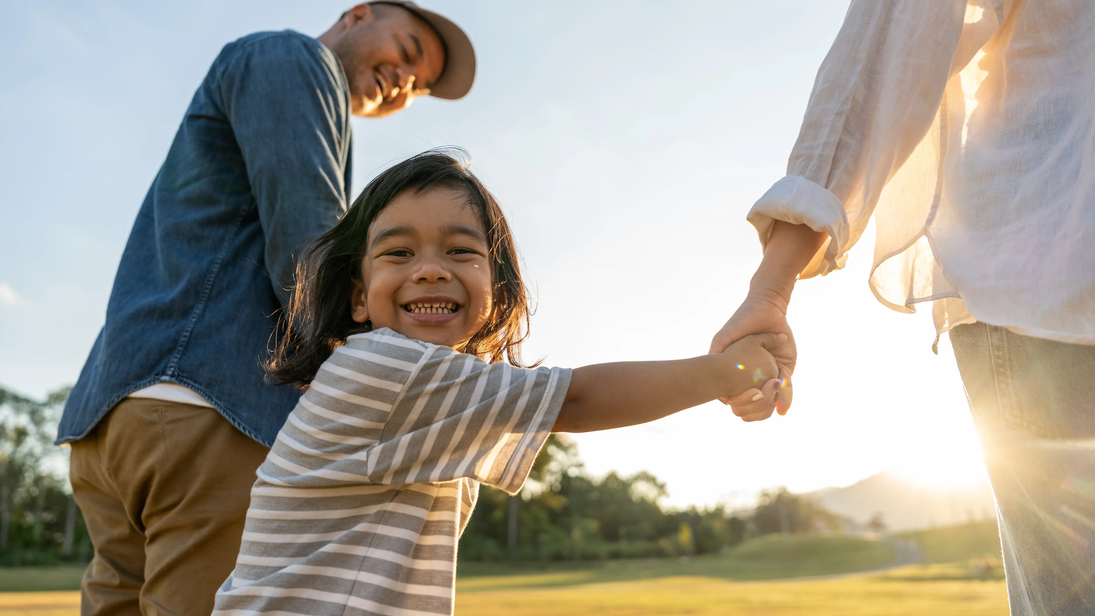child holding parents hands