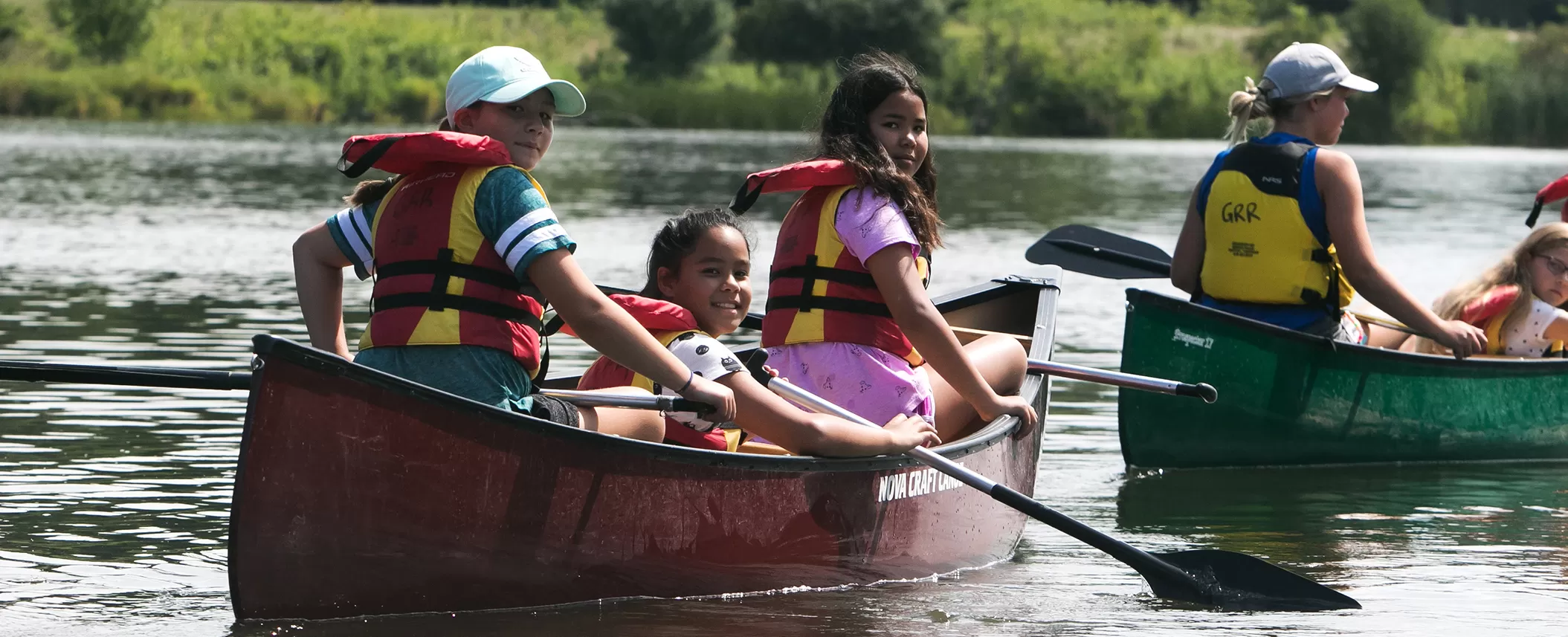 Group of campers canoeing in water at Christie Conservation Park