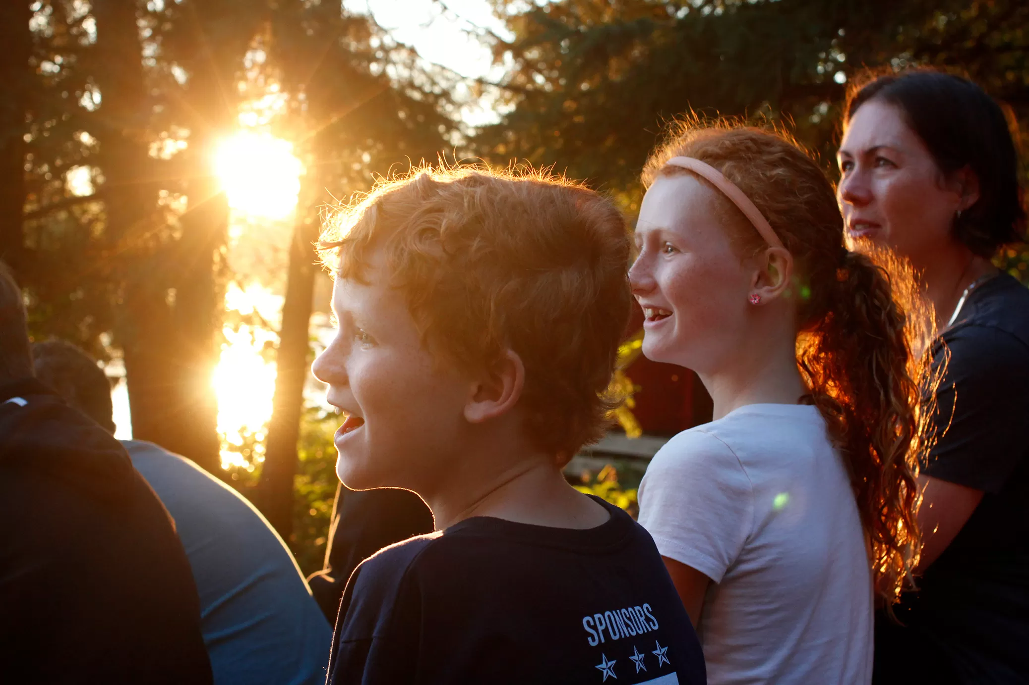Family at waterfront with sunset