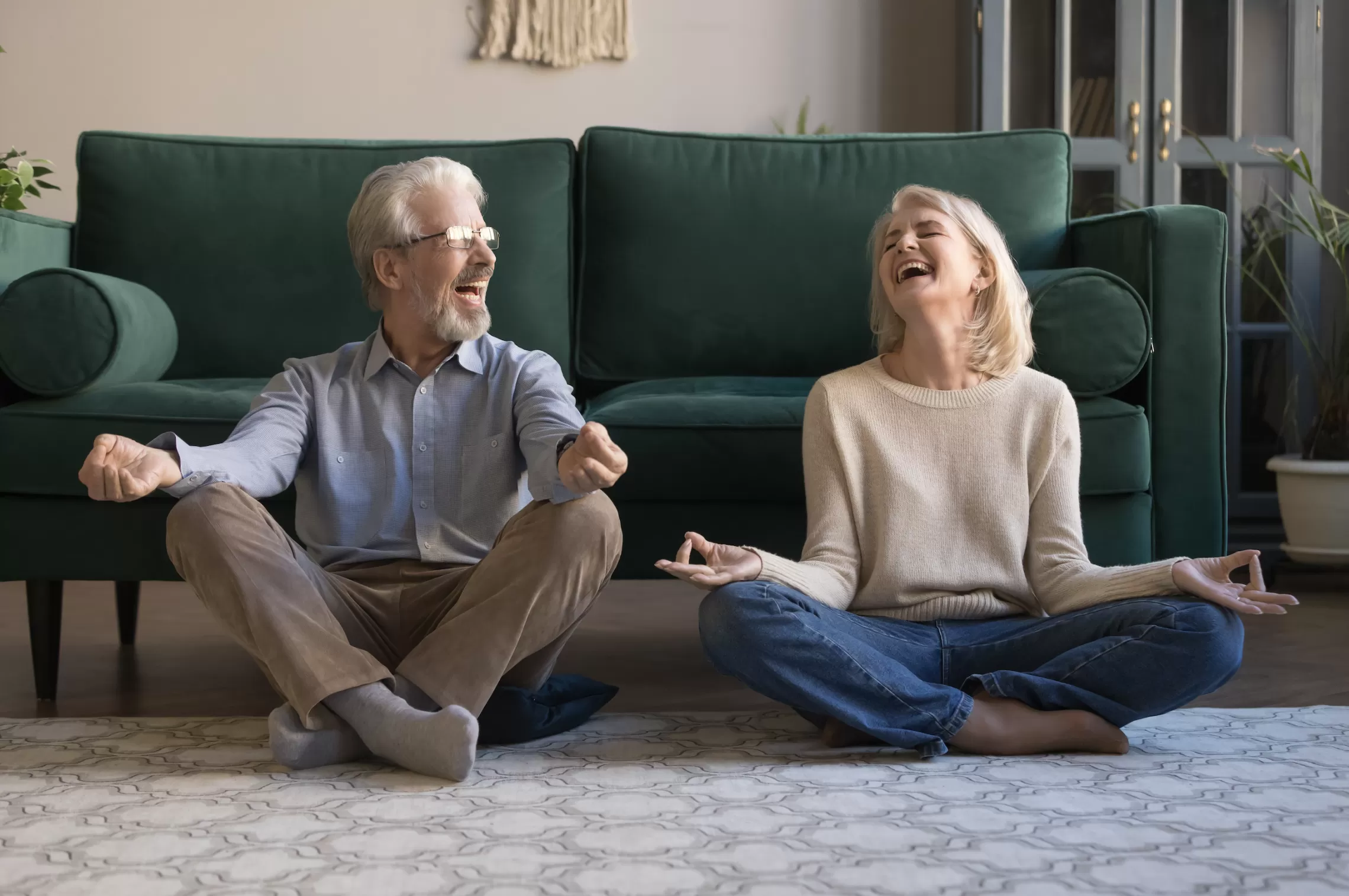 Senior Couple in yoga poses looking at one another and smiling