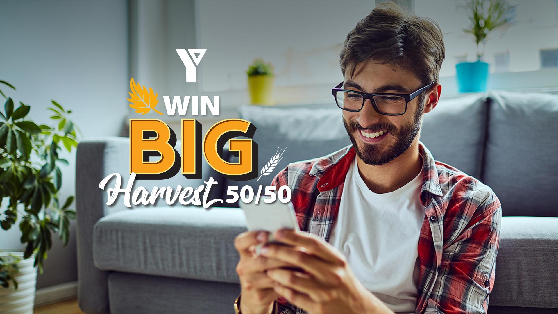 Adult male smiling at phone with text Win Big Harvest 50/50