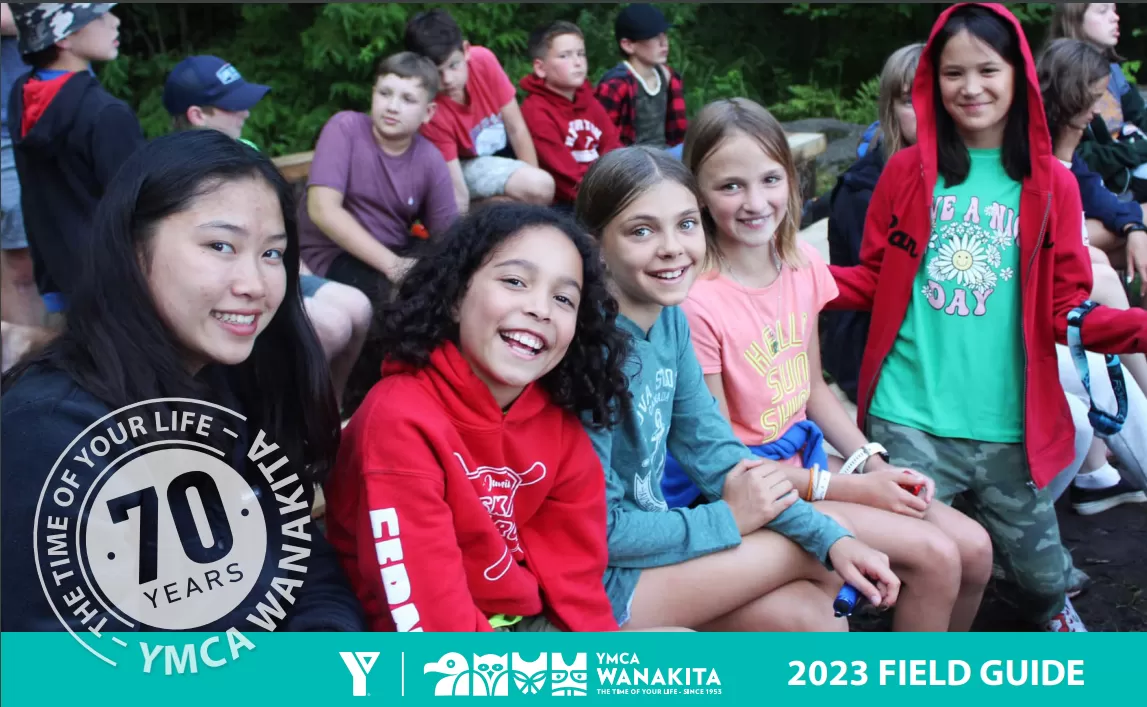 Group of smiling campers on the cover of the 2023 Field Guide