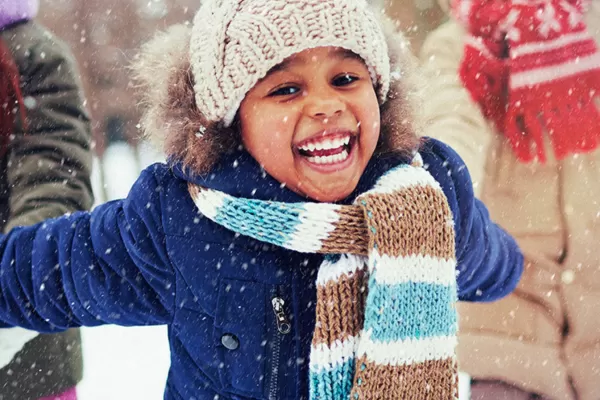 Young girl playing in the snow