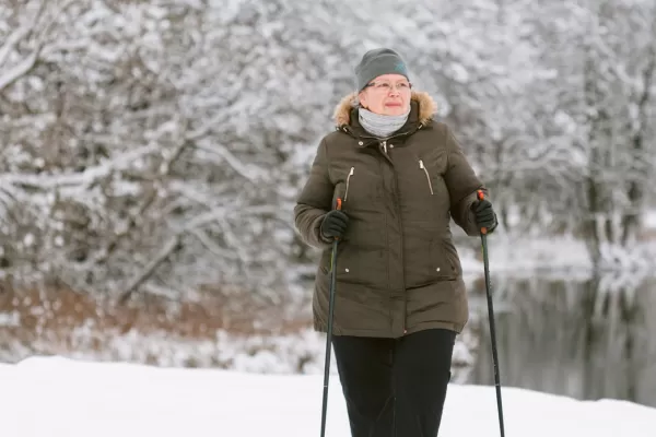 senior women in snow with skis