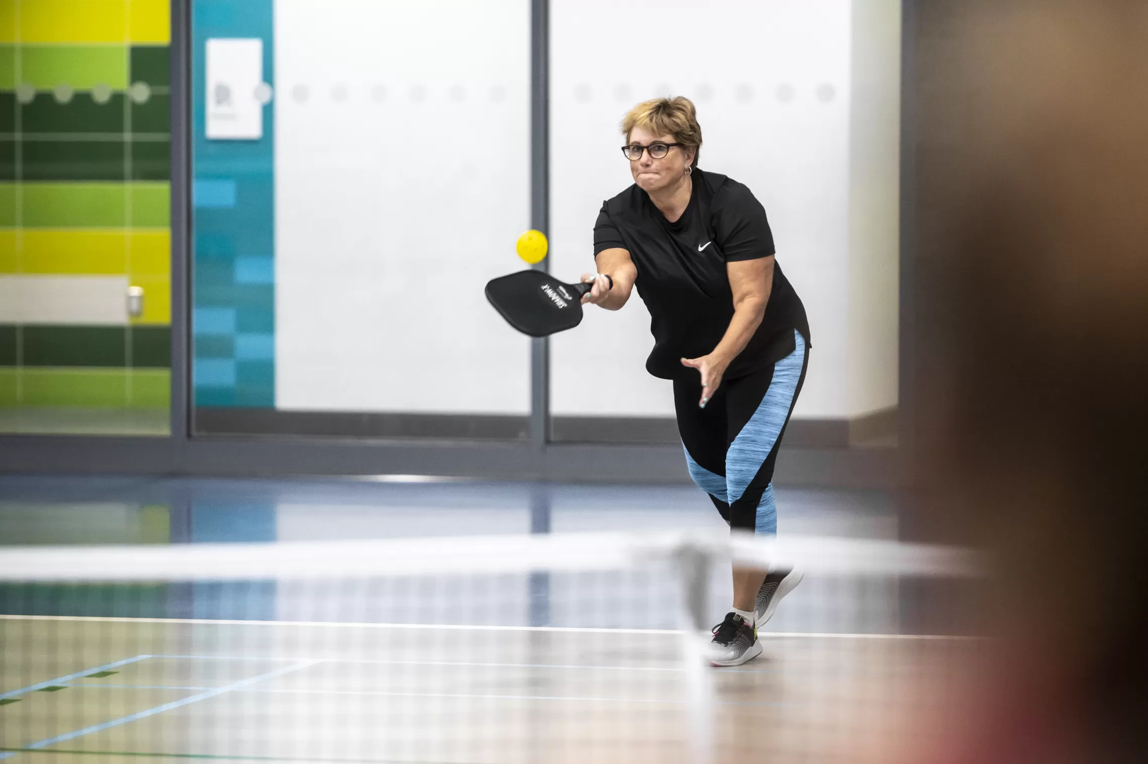 lady playing pickleball on court