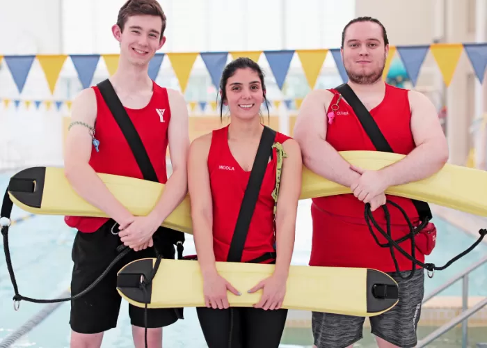 Three Lifeguards standing by pool