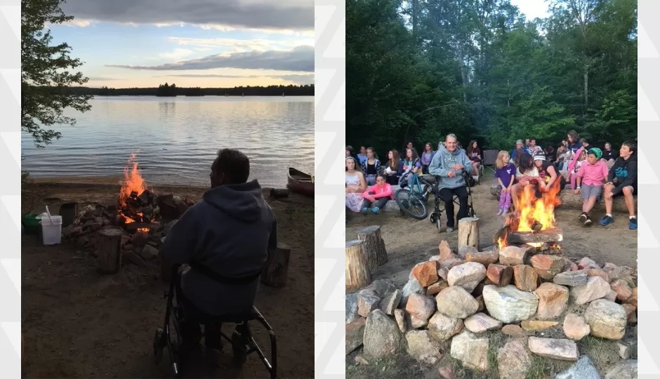 Man in walker sits by campfire in front of lake