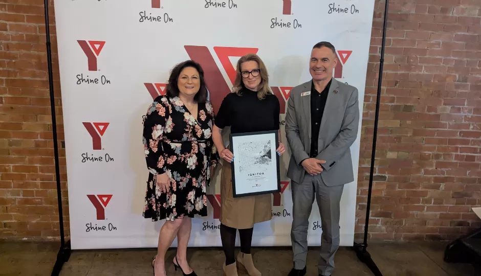 3 people in front of a YMCA banner