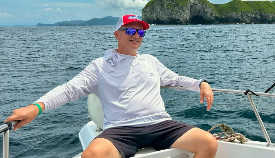 middle aged man on boat in lake