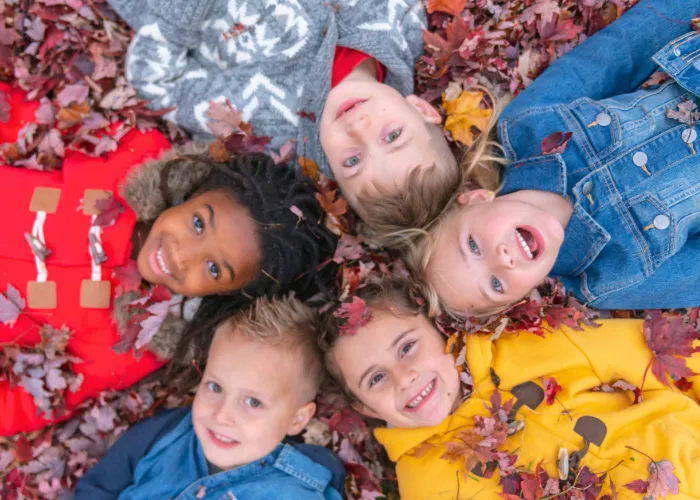 Group of kids laying in leaves
