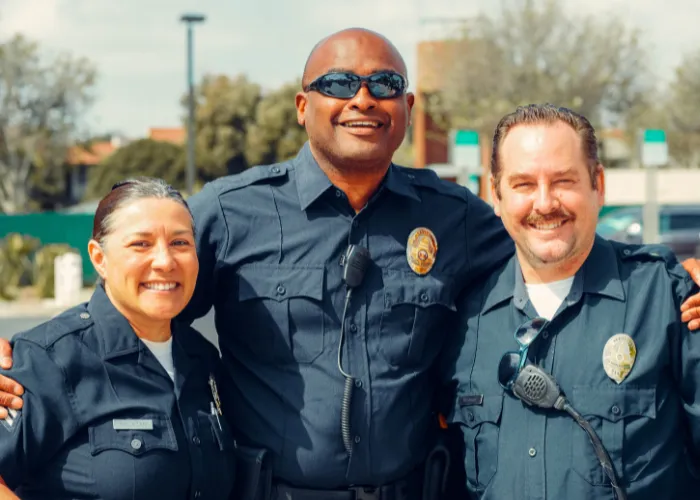 Three police offers smiling