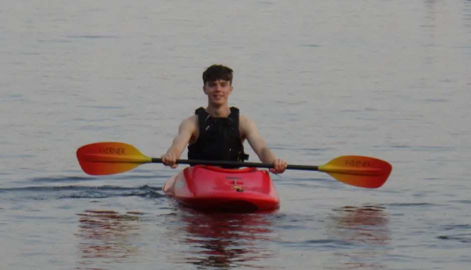young man in kayak on a lake