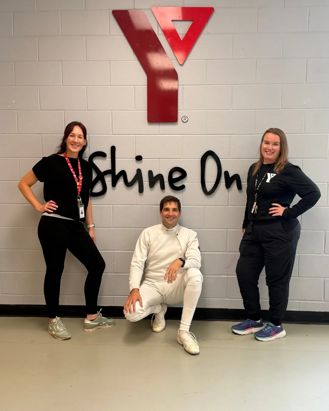 man and two woman in community indoor space