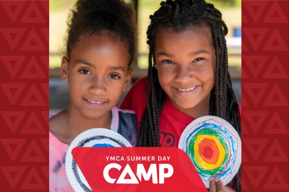 Two girls behind the YMCA Summer Day Camp Promo