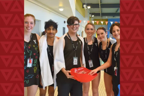 Group of individuals standing holding life saving floater