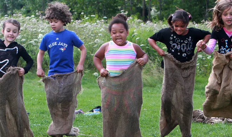Group of campers in potato sack race