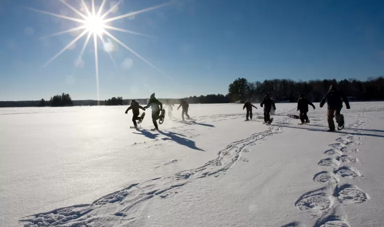 Youth snowshoeing on frozen lake