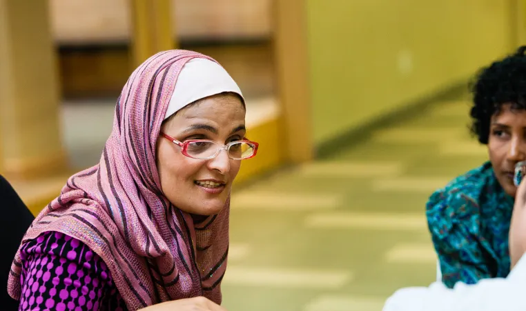 Immigrant woman in group conversation