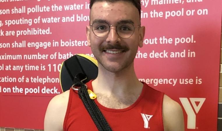 Daniil, a lifeguard at Hamilton Downtown Family YMCA, smiles for a photo.