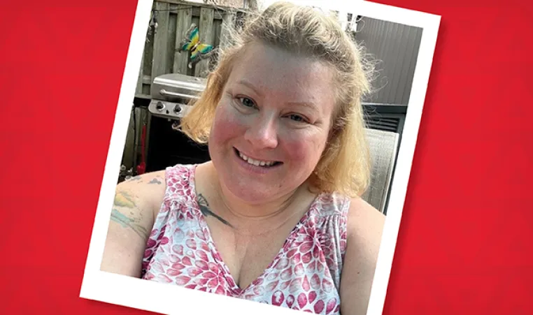 A photo of Angela in her backyard wearing a floral shirt