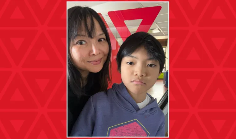 mother and son in front of YMCA sign