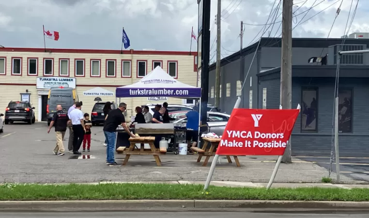 A charity barbeque takes place outside of a lumber store in Hamilton