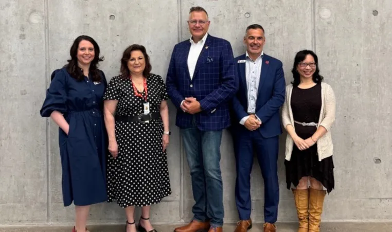 Group of individuals against wall