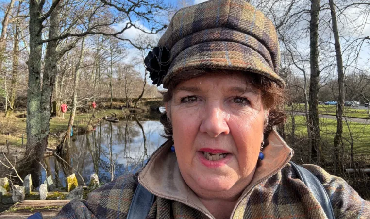 woman in hat takes selfie in natural area