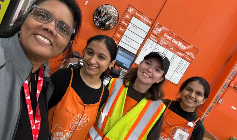 YMCA staff takes photo selfie with home depot employees