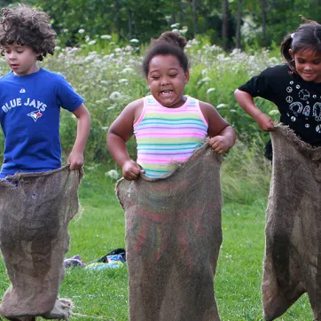 Group of campers in potato sack race