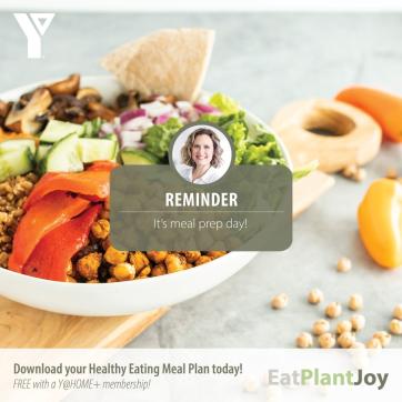 The background contains an image of a healthy prepared meal. There is text overlapped that reads "REMINDER: It's meal prep day!". The text at the bottom of the screen reads "Download your Healthy Eating Meal Plan today! FREE with a Y@Home+ Membership".