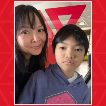 mother and son in front of YMCA sign