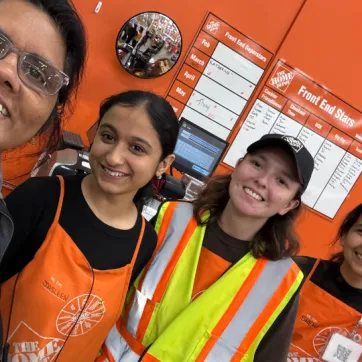 YMCA staff takes photo selfie with home depot employees