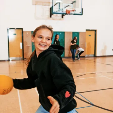 preteen girl dribbles basketball