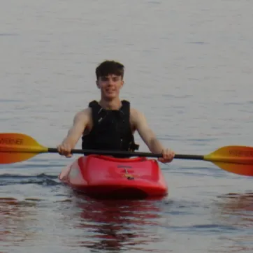 young man in kayak on a lake