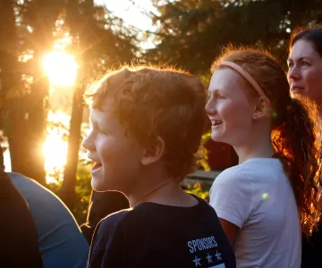 Family at waterfront with sunset