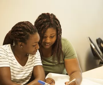 Newcomer youth studying at table