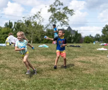 Children play outside with water on a summer day.