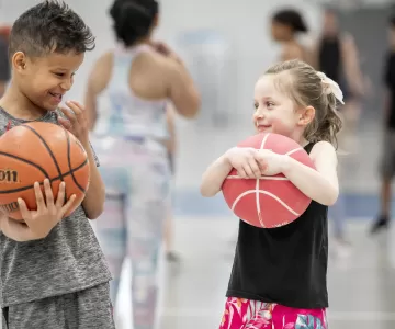 Children Holding Basketballs in Gym