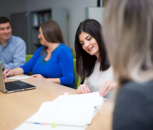 Group of Employment Coaches sitting at table