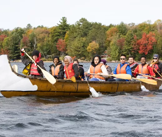 Youth paddling in canoe during Fall programming at Wanakita