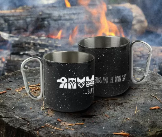 Wanakita mugs sitting by campfire