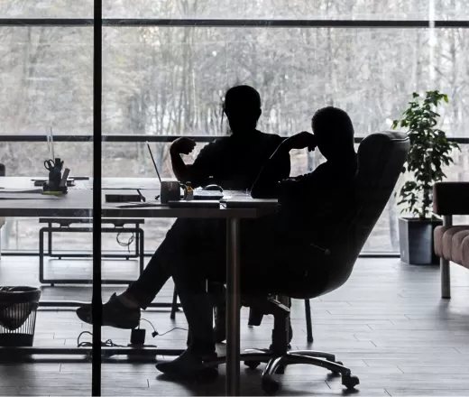 Two people having meeting in large office