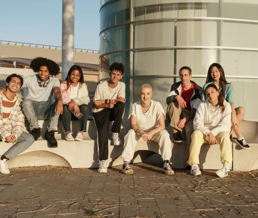 group of diverse youth sitting outside together