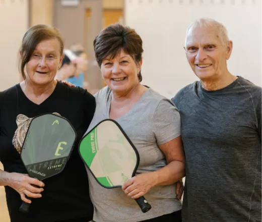 Group of seniors holding Pickleball racquets
